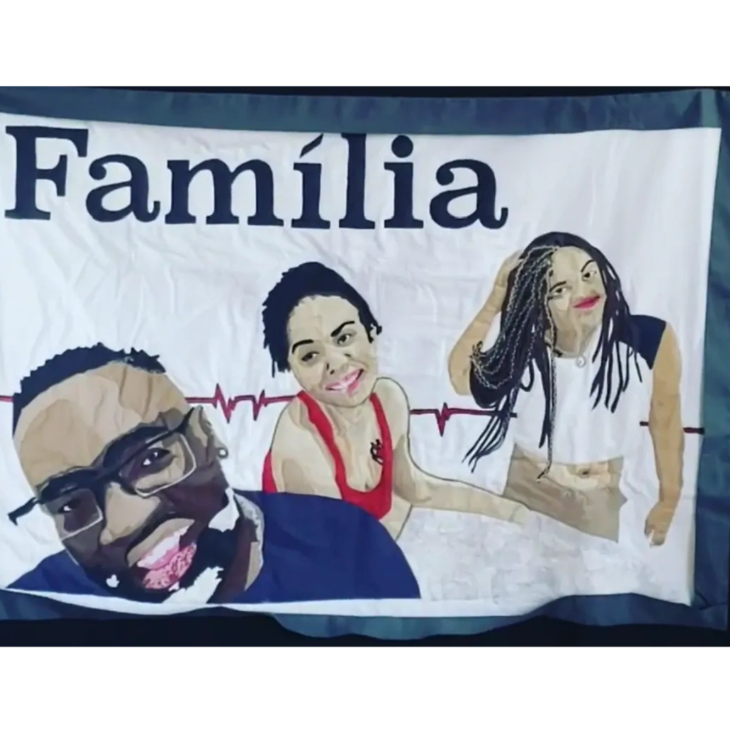The finished Família Quilted Portrait — the same family photo handcrafted in fabric by the maker at Nunu Comforts
